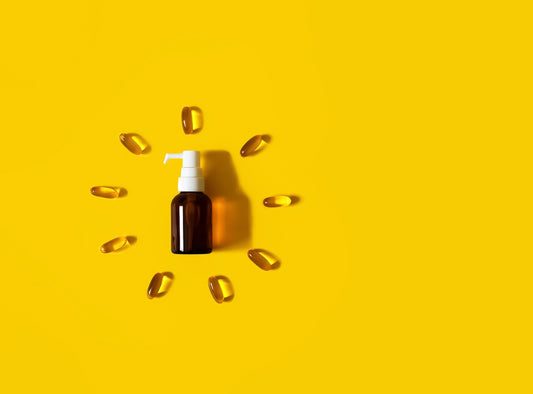 A brown bottle surrounded by yellow oil capsules in the shape of a clock face on a vibrant yellow background, symbolizing fast absorption and daily dosing.